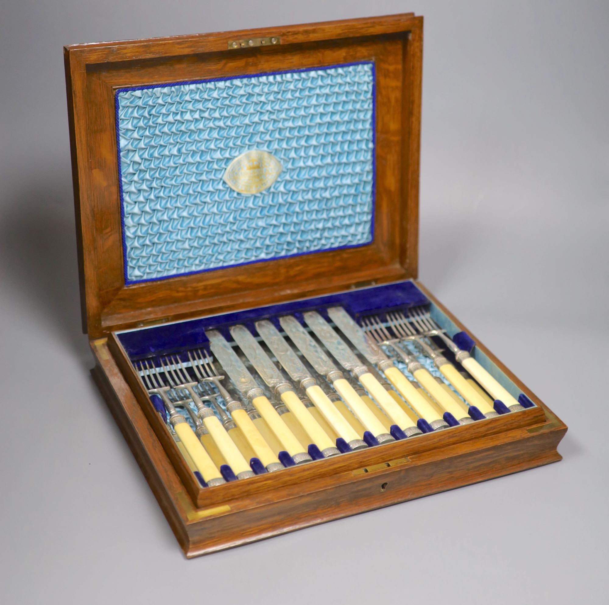 A Victorian oak cased set of twelve pairs of ivory handled silver dessert eaters, Frederick Elkington, Birmingham, 1890, box 34.8cm.